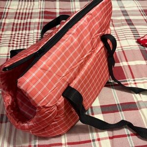 Coral Checkered Dog Carrier and a cream colored dog carrier.